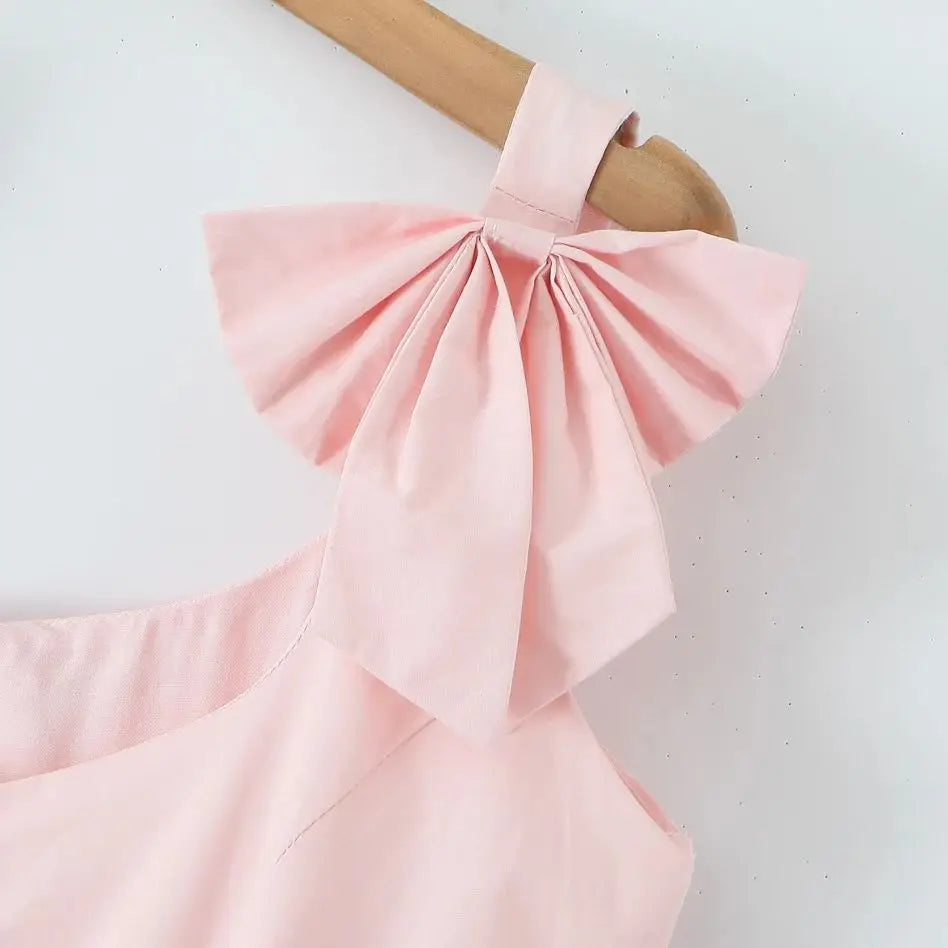 Różowa rozkloszowana sukienka z kokardami